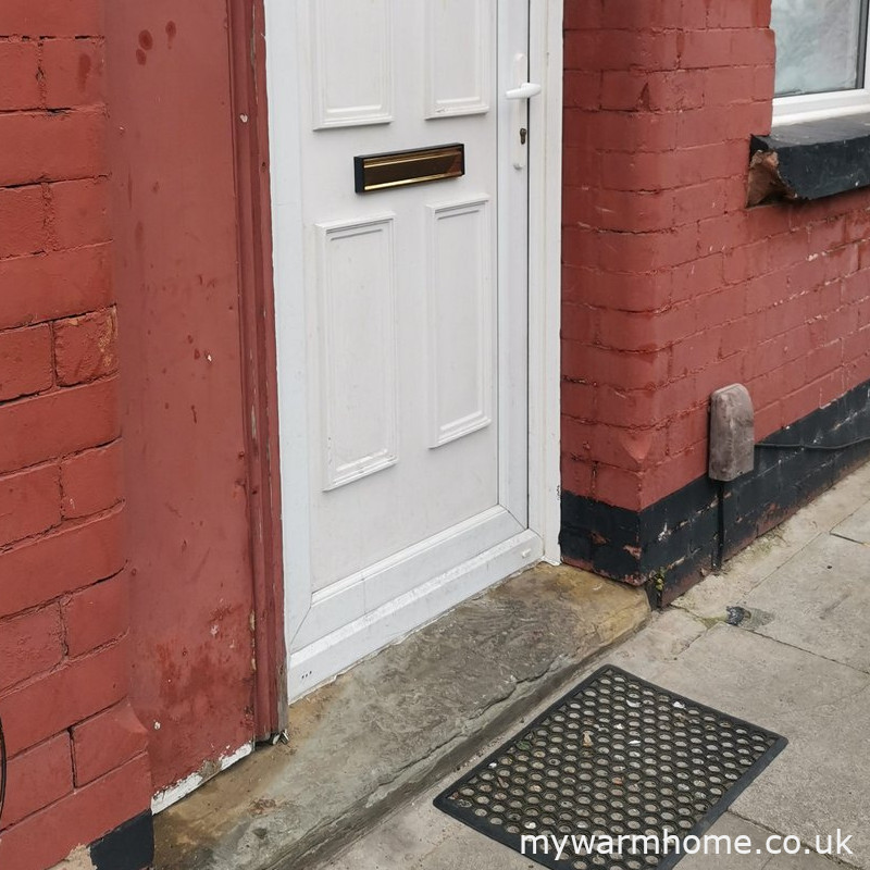 Choose front door — Look at the front entrance in the photograph. What floor construction is most likely in this example?